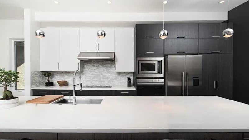 Modern kitchen remodeling in Simpsonville SC with white cabinets, quartz countertops, and stainless appliances by Burch Contracting