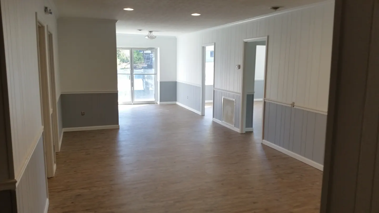 Doctor's office renovation in Mauldin South Carolina with new plank flooring, recessed lighting and painted wall paneling